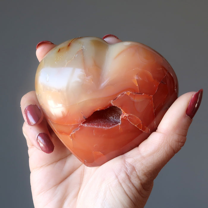 holding Orange Carnelian Heart with Cave