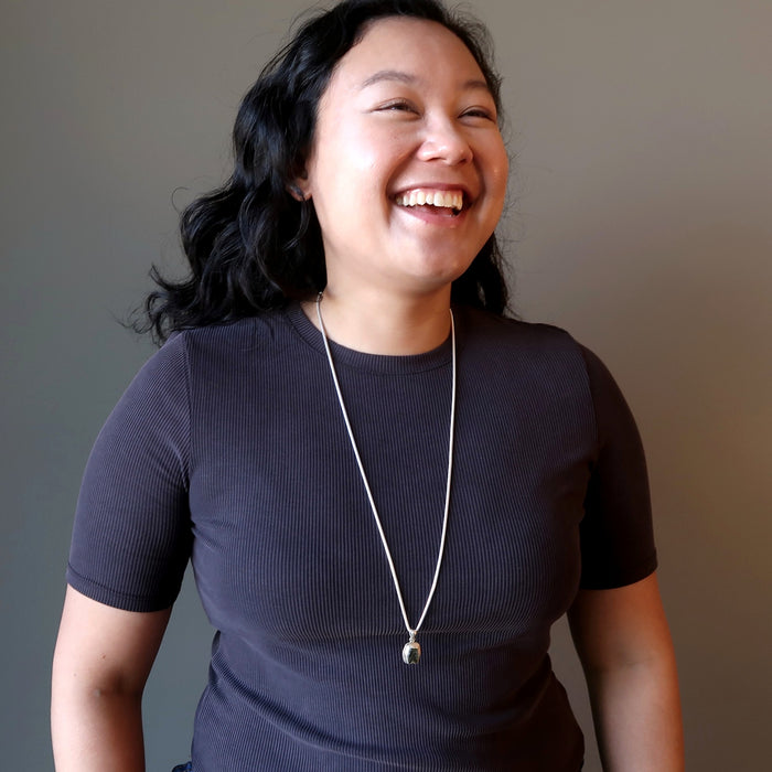 female model wearing a moldavite necklace