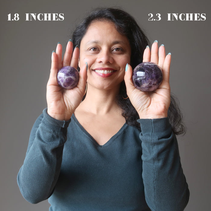 showing the difference between 1.8 and 2.3 inch amethyst spheres