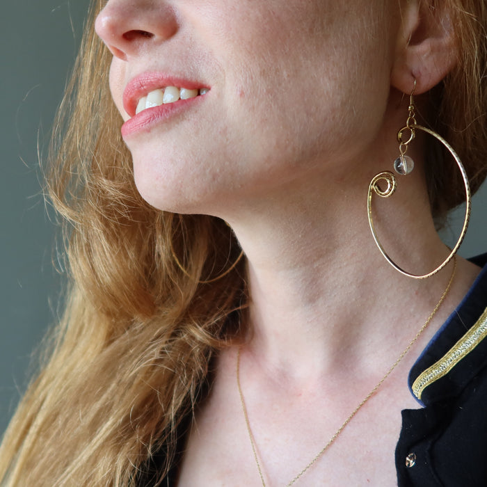 female model wearing Clear Quartz Wrap of Curved Gold Hoop Earrings