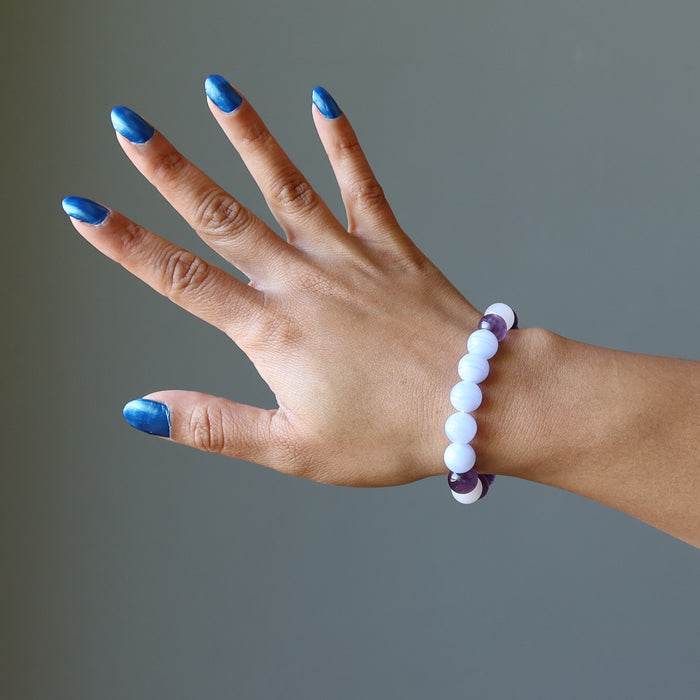 hand wearing blue lace agate, rose quartz, amethyst stretch bracelet for sleep