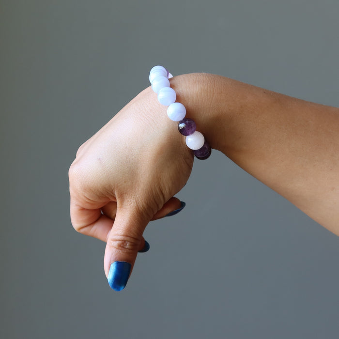 hand wearing blue lace agate, rose quartz, amethyst stretch bracelet for sleep