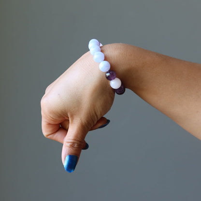 hand wearing blue lace agate, rose quartz, amethyst stretch bracelet for sleep