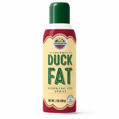A 7 oz aerosol can of Cornhusker Kitchen Gourmet Duck Fat Cooking Oil Spray, featuring a cream-colored label with green lettering and a dark green cap, set against a plain white background.