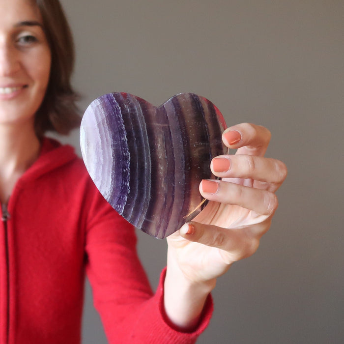 female model holding Purple Fluorite Heart