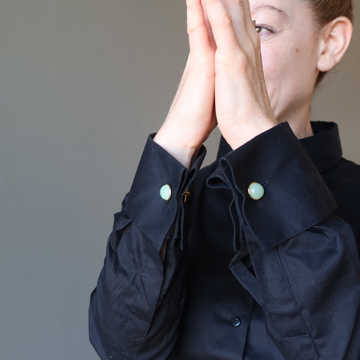 woman in black french cuff shirt wearing green aventurine cufflinks