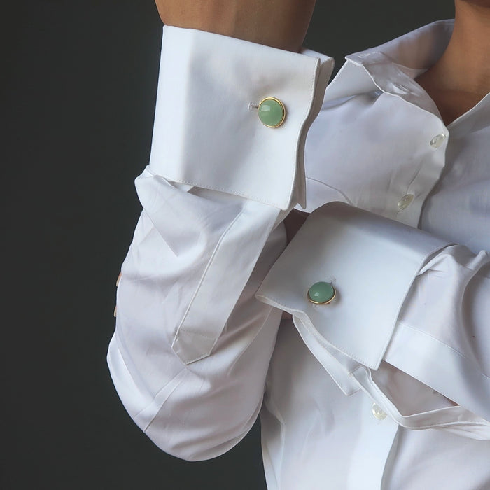woman in white french cuff shirt wearing green aventurine cufflinks