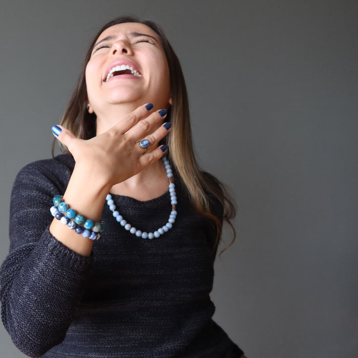 woman wearing blue kyanite oval in adjustable brass ring