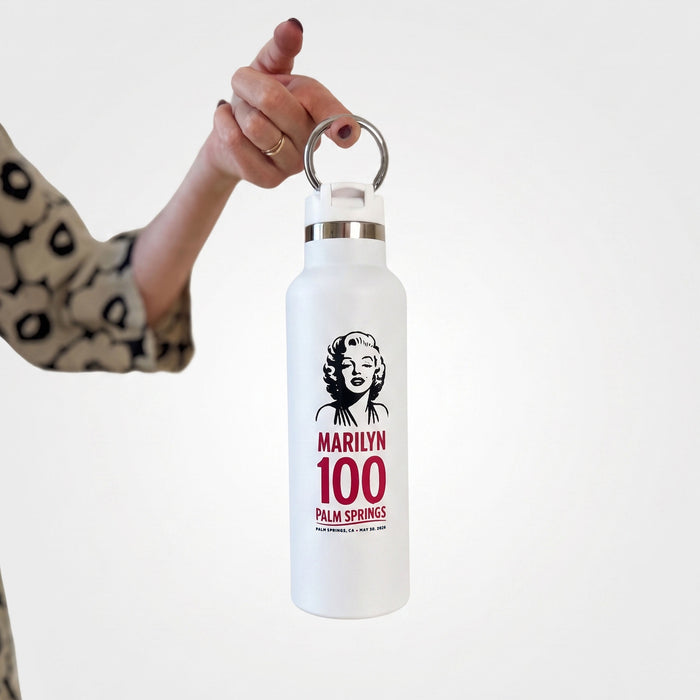 White water bottle with Marilyn Monroe design held by a hand on a white background