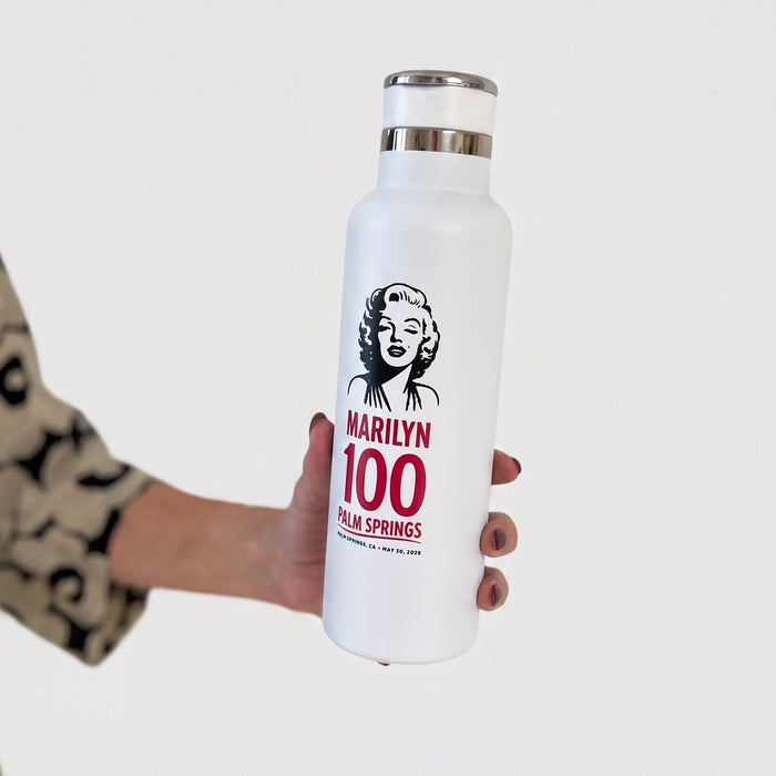 White water bottle with Marilyn Monroe design held by a person against a white background