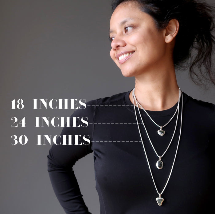 sheila of satin crystals wearing three strands of moldavite necklaces