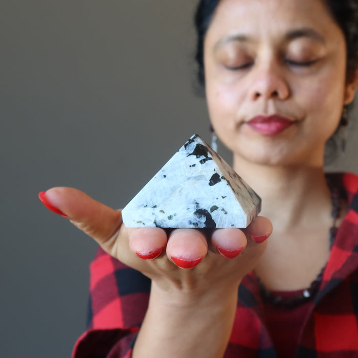 female meditating with moonstone tourmaline pyramid