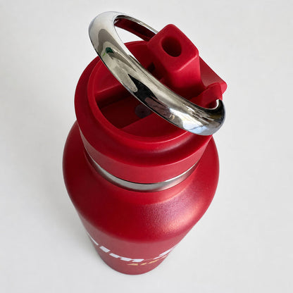 A red insulated water bottle with a matching red lid and a shiny silver metal carrying loop, shown on a plain light background.