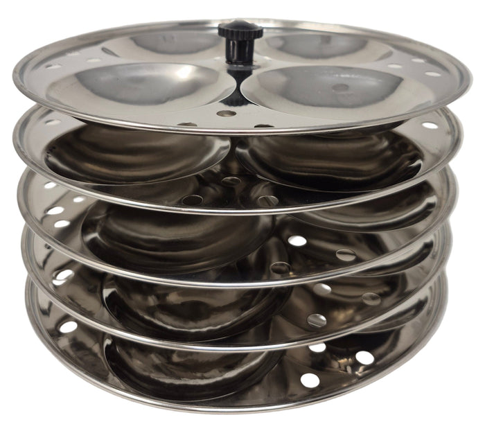Stack of metal trays with circular holes on a white background